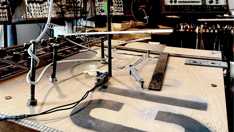 DIY noise board — springs, bell and kalimba mounted on a wooden board